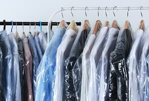 Dry cleaned clothes on hangers
